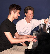 Andy Ostwald teaching a piano student